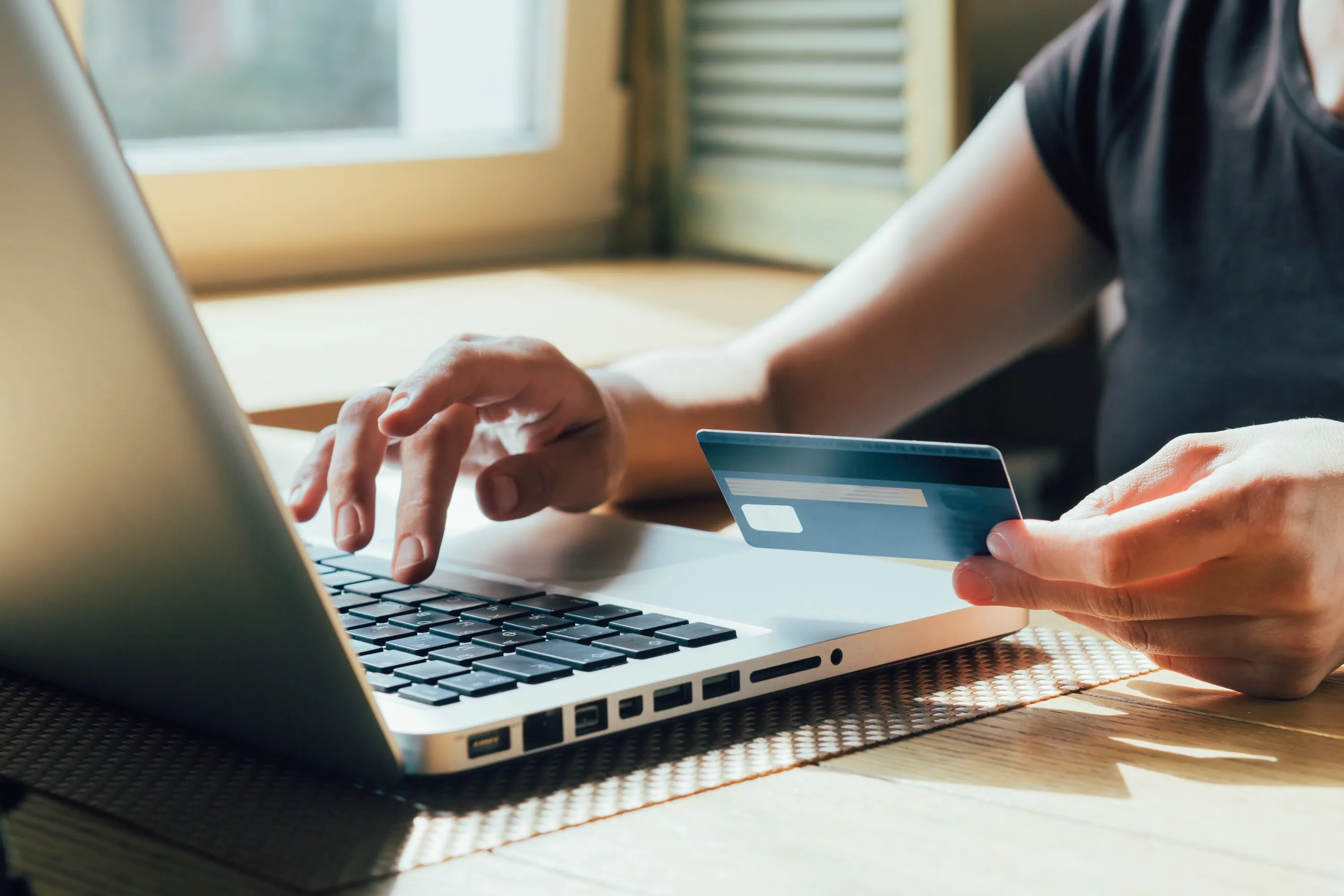 Person entering payment details online, representing secure cloud transaction protection for businesses