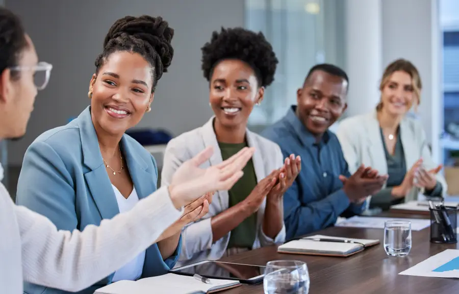 Diverse Africa business team applauding at partner onboarding orientation welcoming new consortium members.