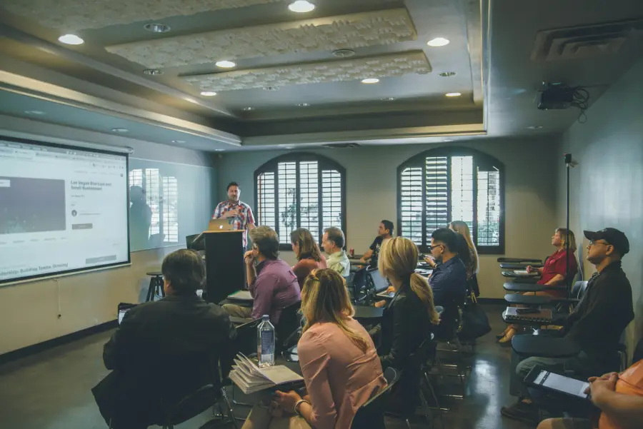 Presenter speaks to a group of professionals seated in a conference room during a Las Vegas startup and small business sem...