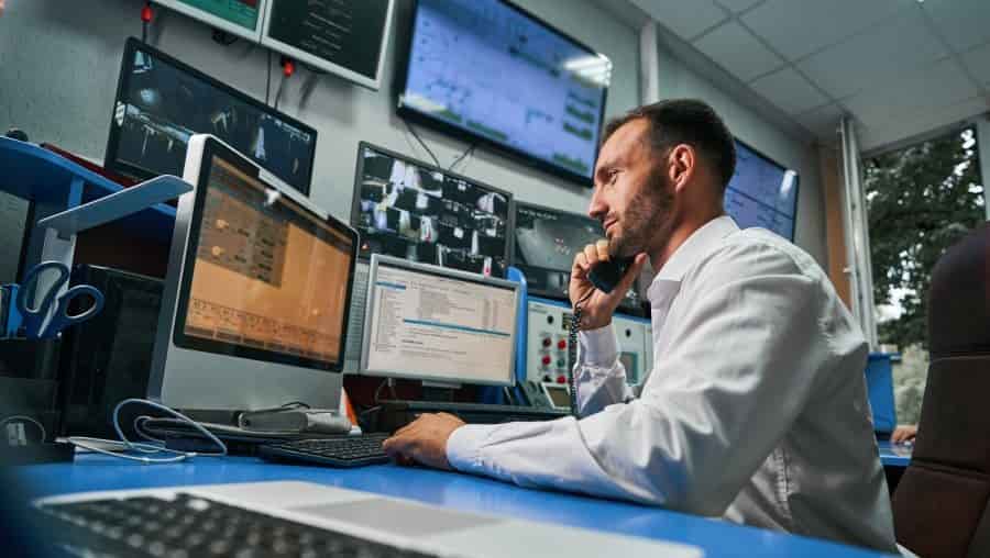 Server technician answering phone call from control room