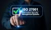 A person hand with ISO 27001 and a check mark