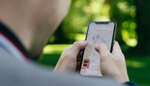 Traveler using a mobile map app to navigate a group trip itinerary