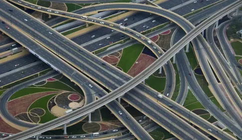A multi level motorway interchange photographed from the air, its ramps crossing over one another.