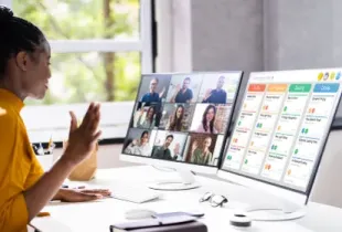 A Black woman in a yellow shirt on a video call