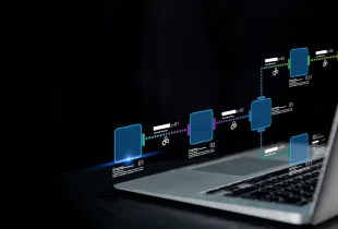 Holographic IT workflow diagram with numbered process nodes above a laptop, representing enterprise automation.