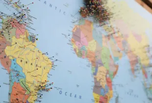 A political world map showing named countries, marked with pins across several continents.