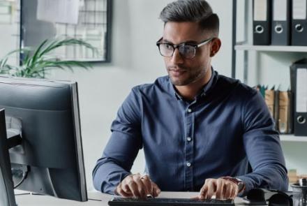 A man staring at a laptop