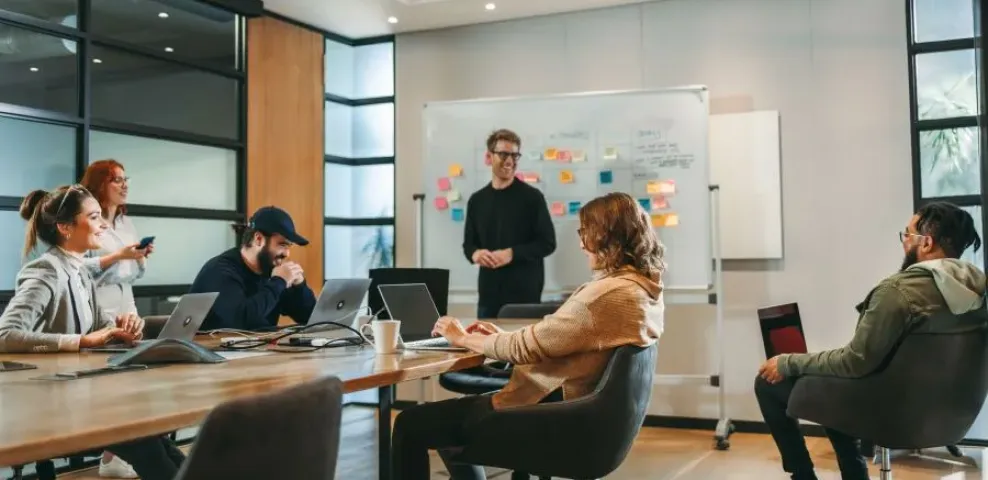 Group of professionals planning website design with a vision board for managed hosting services