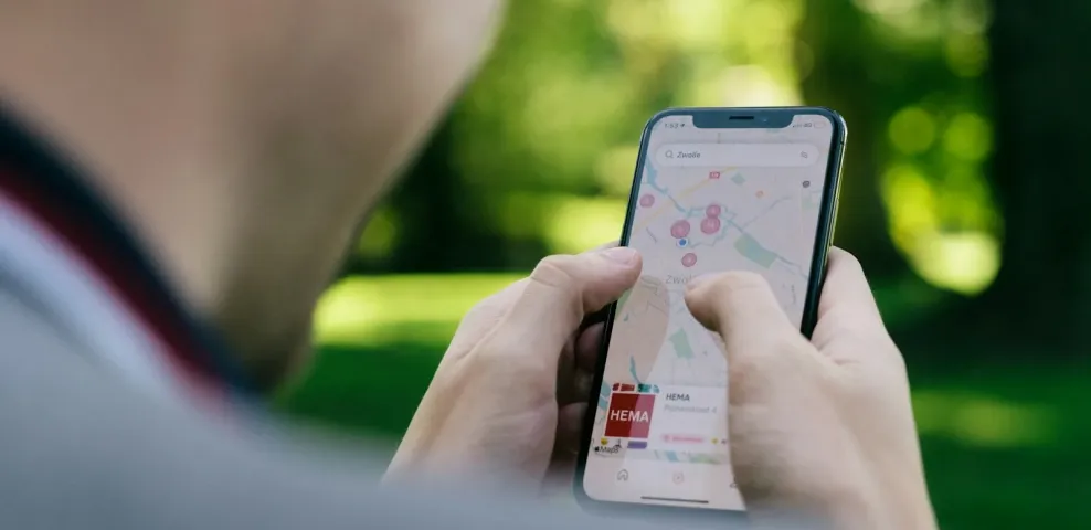 Traveler using a mobile map app to navigate a group trip itinerary